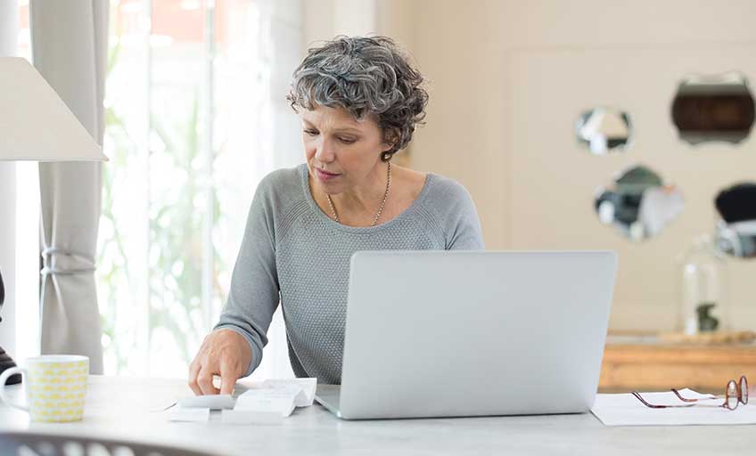image of older woman checking the bill