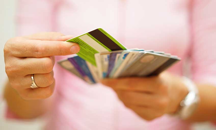 A man holding many cards.