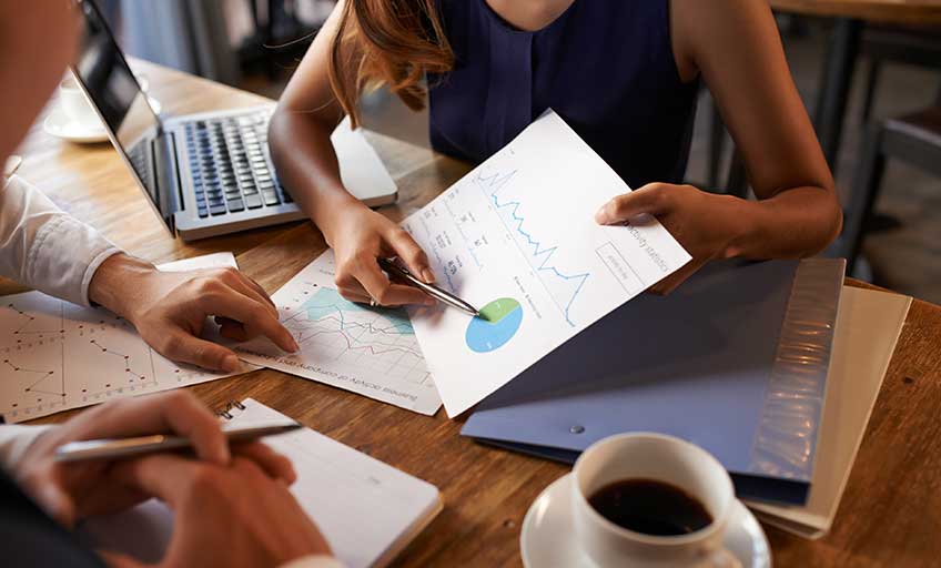 A woman analyzing a financial graph