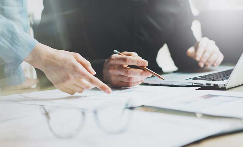 A person reviewing documents at a desk