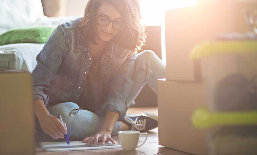 Individual writing to prepare for tax time