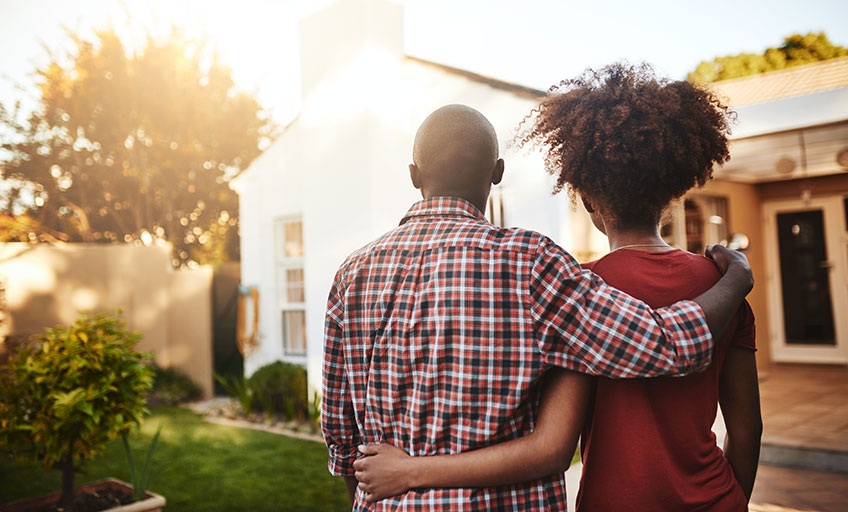 A couple facing towards their new home