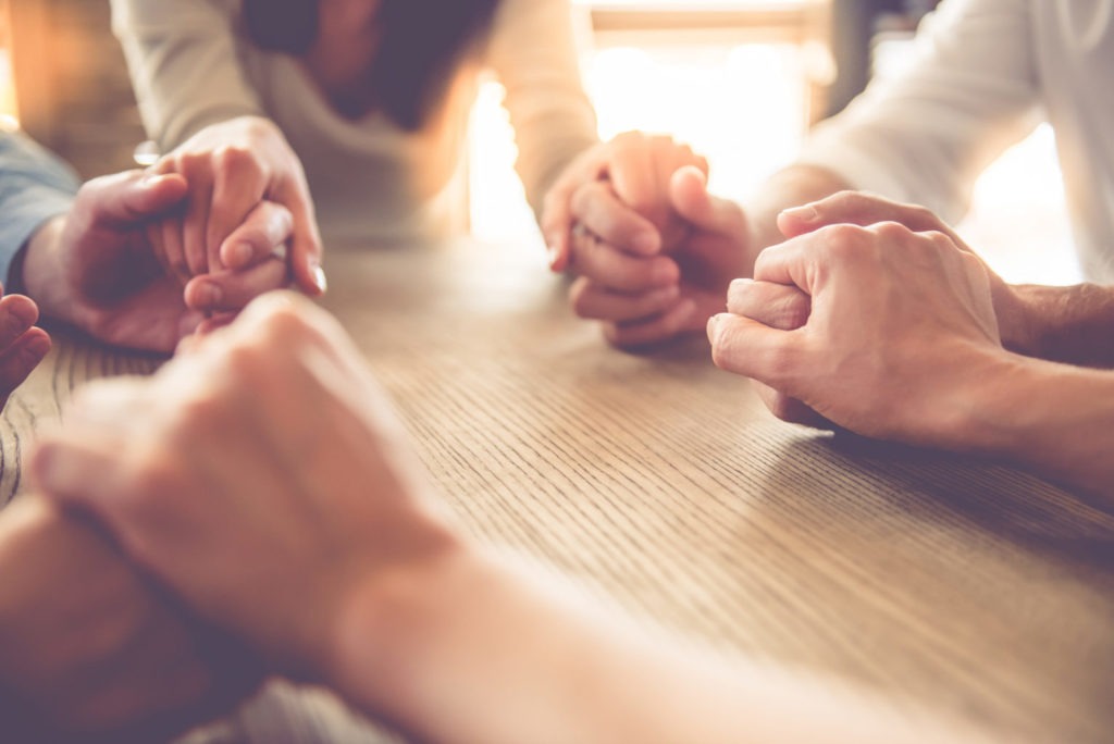 Group of people holding hands