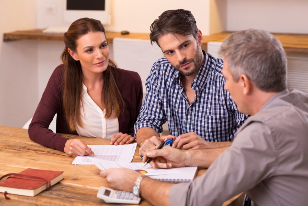 A couple discussing their financial plan with an advisor