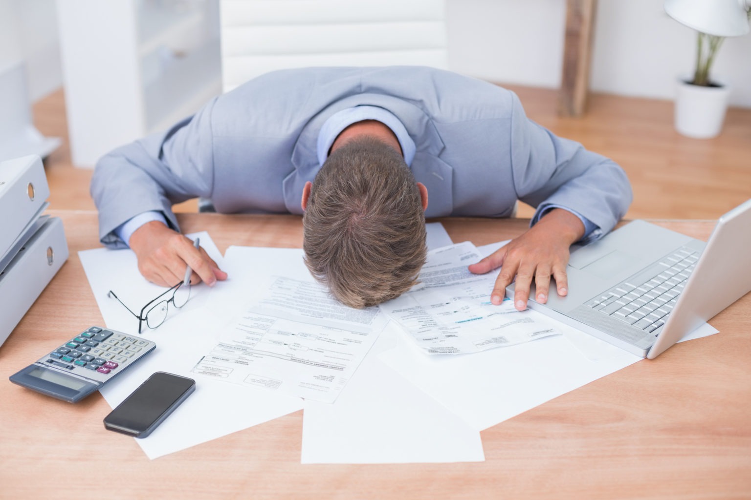 Businessman being depressed by accounting Businessman being depressed by accounting in his office