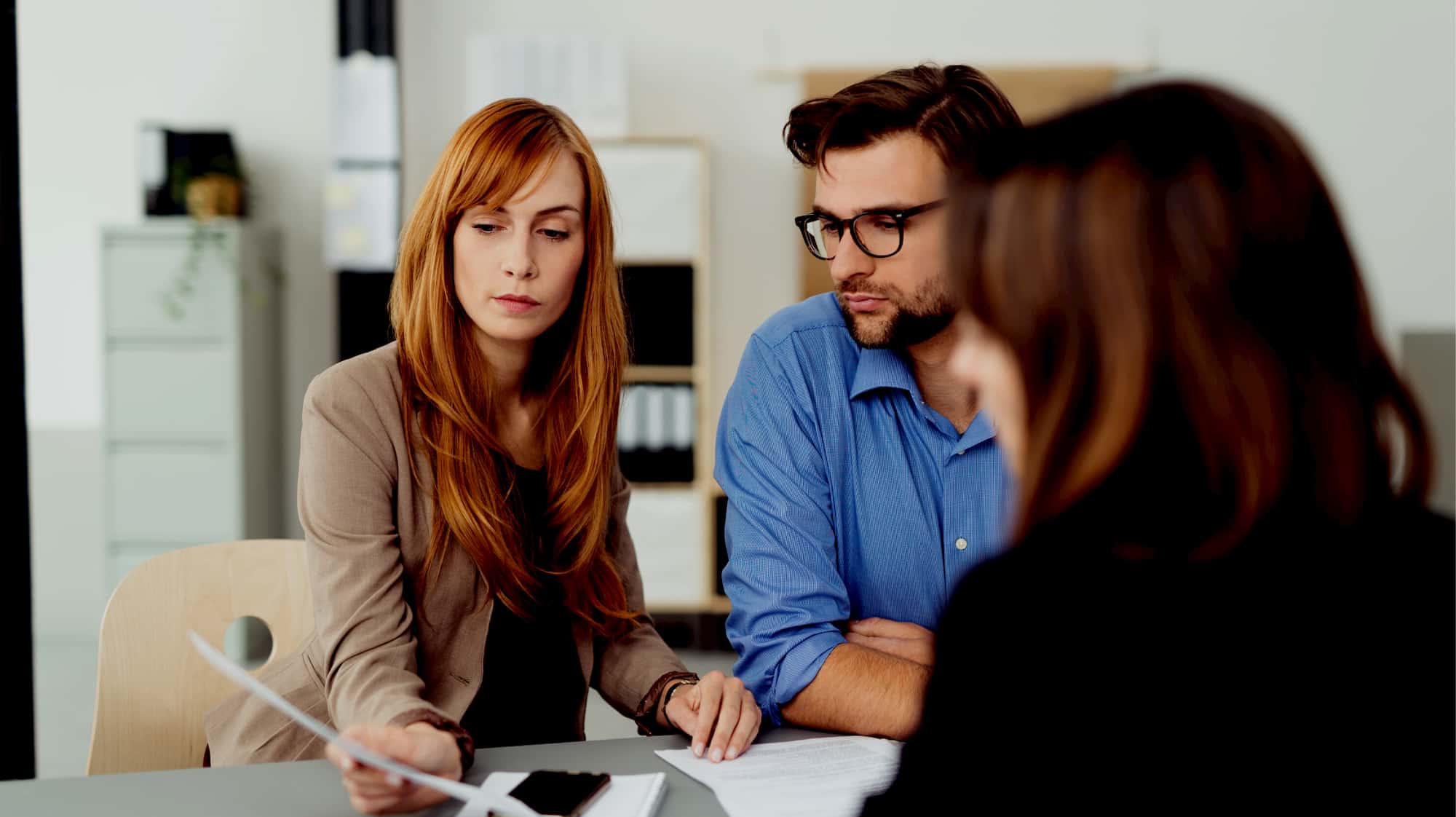 An image of professionals discussing at a table.
