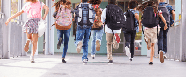 An image of children with school bags
