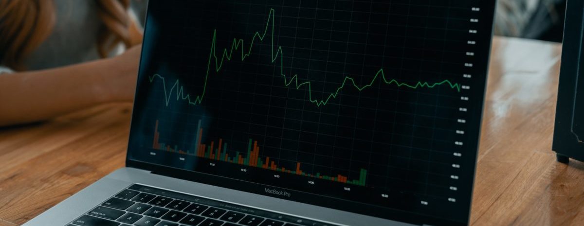 An image of a laptop displaying a graph on the screen