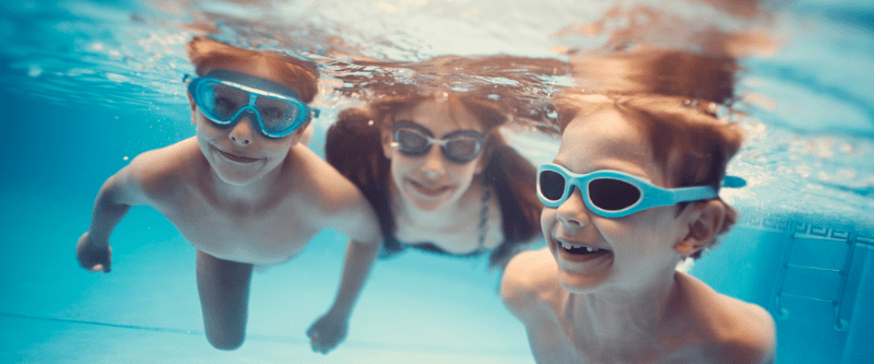 Kids having fun swimming in the pool